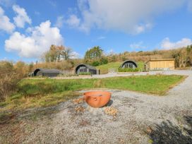 Holiday pods with a wooden structure at Lodge 2 near Pontyates