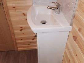 A sink with a faucet and cabinet at Lodge 3 in Pontyates