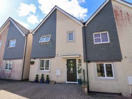 A house exterior with a front door and windows at 21 Olympic Way Plymouth