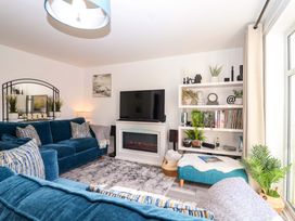 A living room with a sofa and television at 21 Olympic Way Plymouth