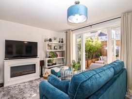 A living room with a television, fireplace, and sofa at 21 Olympic Way Plymouth