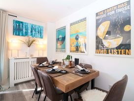 A dining room with a wooden table and chairs at 21 Olympic Way Plymouth