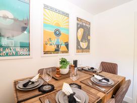 A dining room with a table set for a meal at 21 Olympic Way Plymouth