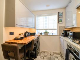 A kitchen with appliances and seating at 21 Olympic Way Plymouth