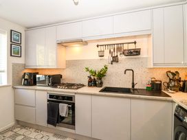 A kitchen with sink and appliances at 21 Olympic Way in Plymouth