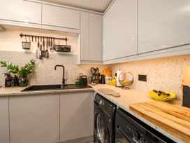 A kitchen with a sink and washing machine at 21 Olympic Way Plymouth