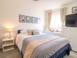 A bedroom with a bed and television at 21 Olympic Way Plymouth
