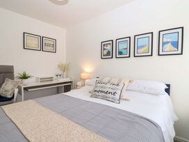 A bedroom with a bed and desk at 21 Olympic Way Plymouth