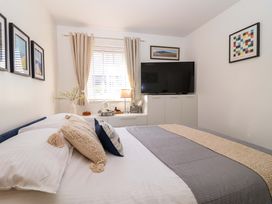 A bedroom with a bed, television, and window at 21 Olympic Way in Plymouth