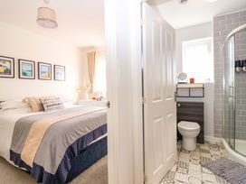 A bedroom with a bed and an adjoining bathroom at 21 Olympic Way Plymouth