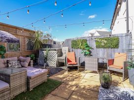 A garden with seating area and potted plants at 21 Olympic Way Plymouth