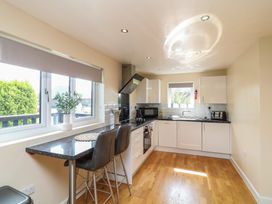 A kitchen with cabinets and a sink at James Ville Marina Lodge 10 in Brigg