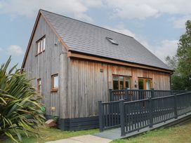 A wooden house with a ramp and deck at James Ville Marina Lodge 10 in Brigg
