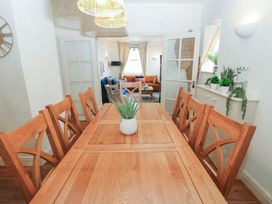 A dining room with a wooden table and chairs at Hampton House St. Bees