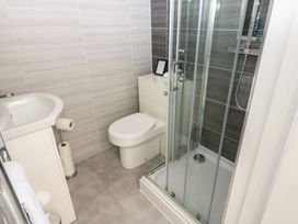 A bathroom with a shower, sink, and toilet at Hampton House St. Bees