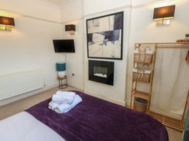 A bedroom with a bed and a television at Hampton House St. Bees
