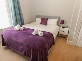 A bedroom with a bed and nightstand at Hampton House in St. Bees