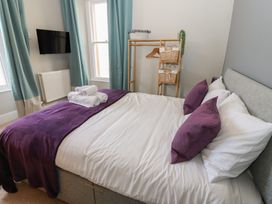 A bedroom with a bed and TV at Hampton House in St. Bees