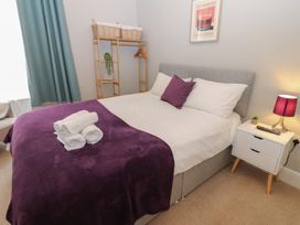 A bedroom with a bed and a bedside table at Hampton House in St. Bees