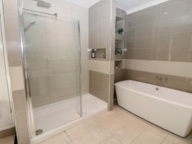 A bathroom featuring a shower and a bathtub at Hampton House in St. Bees