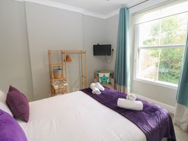 A bedroom with a bed and a TV at Hampton House in St. Bees