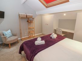 A bedroom with a bed and desk at Hampton House St. Bees