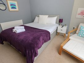 A bedroom with a bed and side table at Hampton House in St. Bees