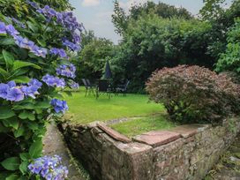 A garden with flowers and seating area at Hampton House in St. Bees