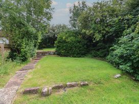 A garden with grass and trees at Hampton House St. Bees