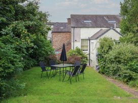 A garden with a table and chairs at Hampton House in St. Bees