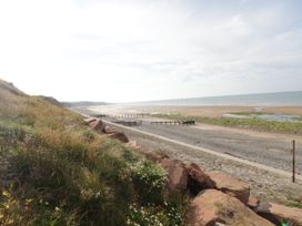 A beach with sand and ocean at Hampton House in St. Bees