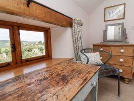 A bedroom with a window and a dressing table at Lane End in North Molton