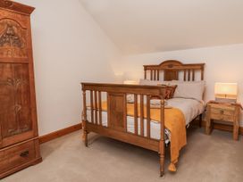 A bedroom with a bed and wardrobe at Lane End in North Molton