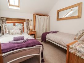 A bedroom with two beds and a window at Lane End in North Molton