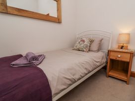 A bed with a pillow and towel in a bedroom at Lane End North Molton