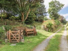 A gate and bench by a gravel path at Lane End North Molton