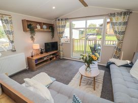 A living room with a sofa and TV at Barnes Retreat in Carnforth