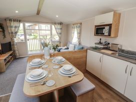 A kitchen with a dining table set at Barnes Retreat Carnforth