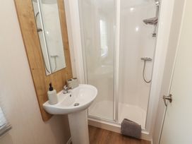 A bathroom featuring a shower and sink at Barnes Retreat in Carnforth