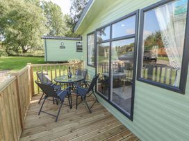 A deck area with a table and chairs at Barnes Retreat in Carnforth