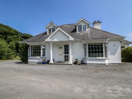 A house with a front door and windows at Knockroe Lodge in 