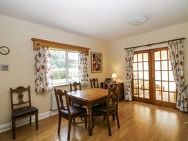 A dining room with a table and chairs at Knockroe Lodge