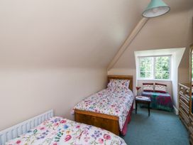 A bedroom with two beds and a window at Knockroe Lodge