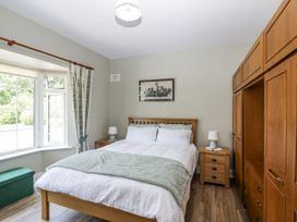 A bedroom with a bed and wardrobe at Knockroe Lodge