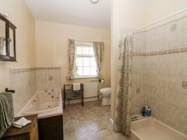 A bathroom with a bathtub, shower, and toilet at Knockroe Lodge