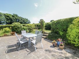 A table with chairs in a garden at Knockroe Lodge