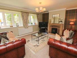 A living room with a television and a fireplace at Scalby Grove Cottage in Scalby