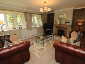 A living room with a sofa and coffee table at Scalby Grove Cottage in Scalby