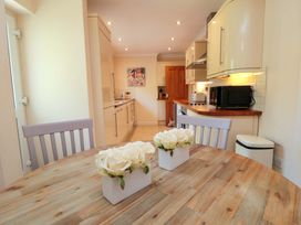 A kitchen with a dining table and chairs at Scalby Grove Cottage in Scalby