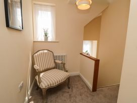 A landing area with an armchair and a window at Scalby Grove Cottage in Scalby